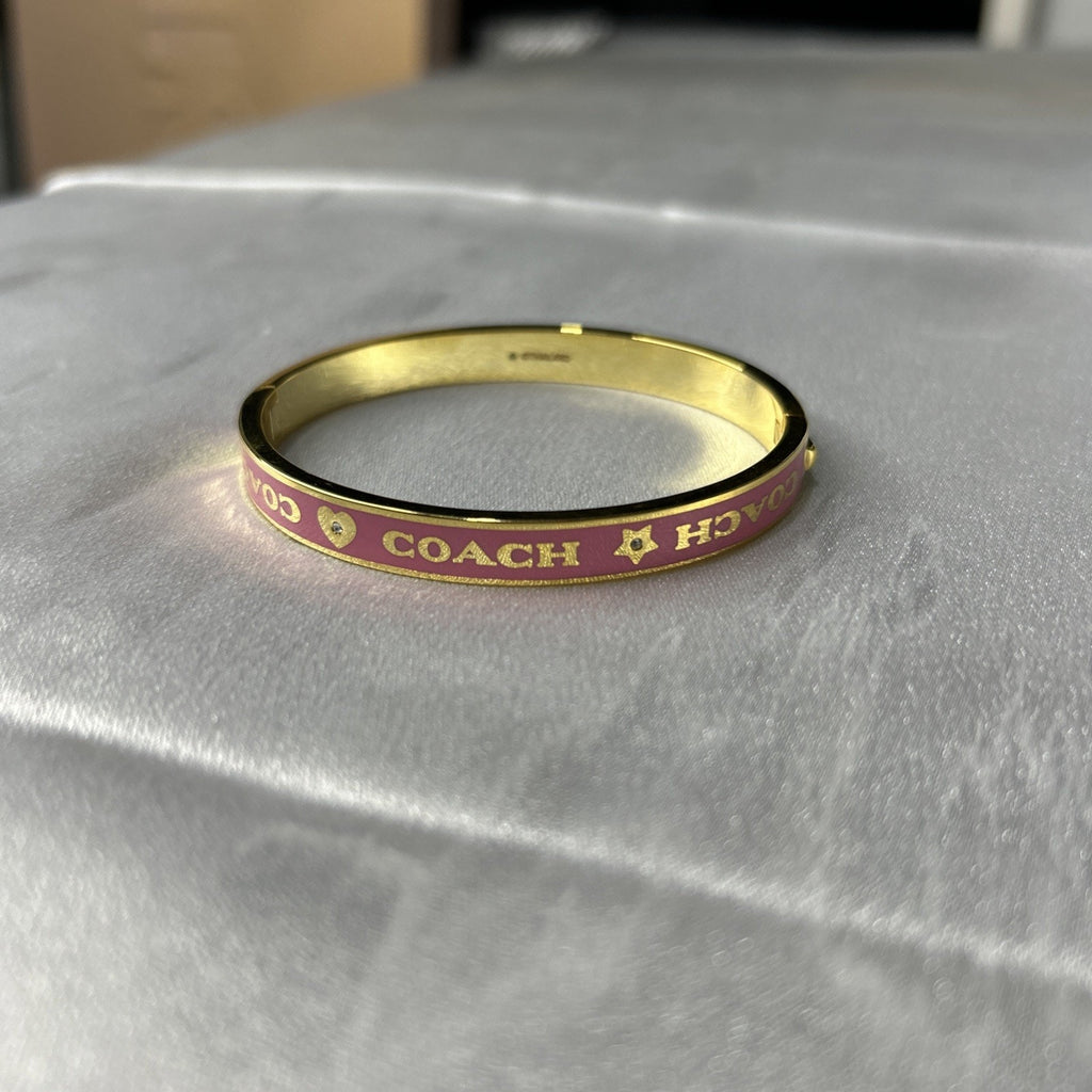 COACH PINK / GOLD HEART AND STAR ENAMEL BANGLE