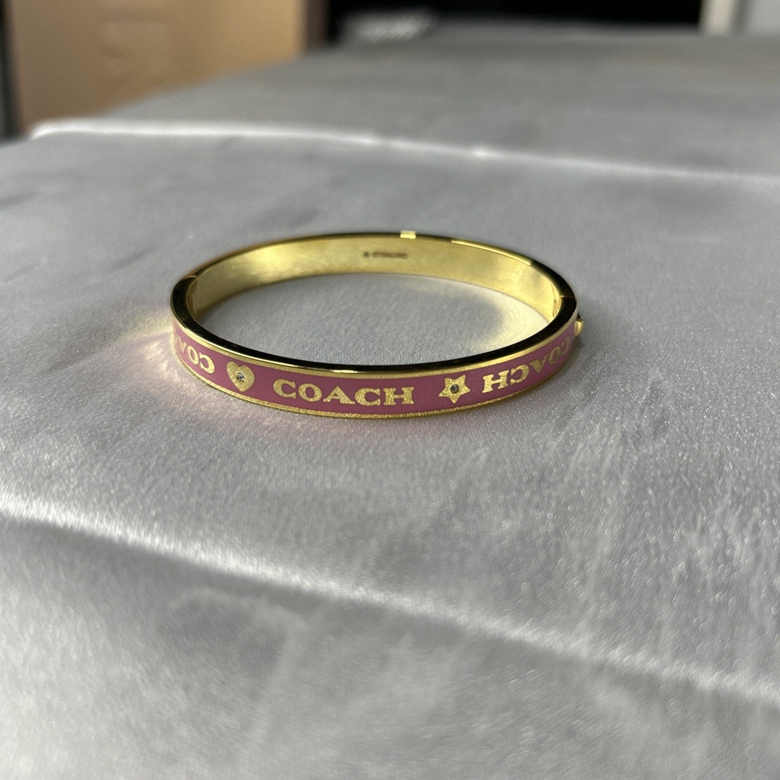 COACH PINK / GOLD HEART AND STAR ENAMEL BANGLE
