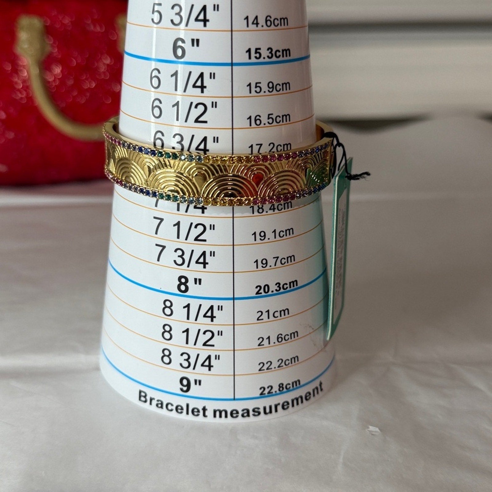Kurt Geiger gold bangle with multi color
Stones