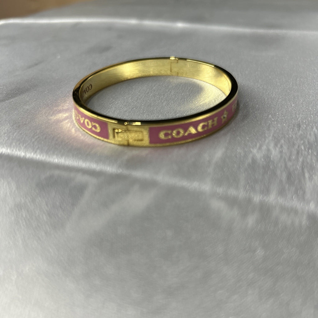 COACH PINK / GOLD HEART AND STAR ENAMEL BANGLE