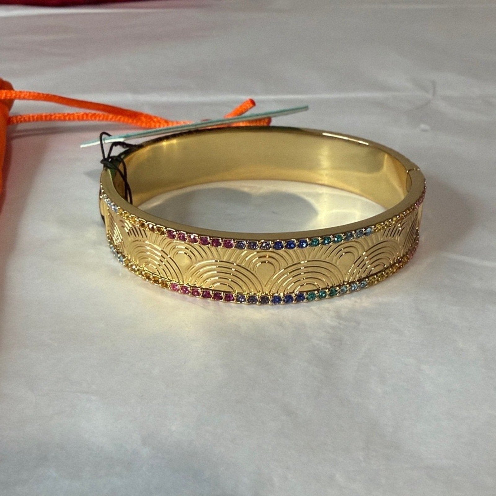 Kurt Geiger gold bangle with multi color
Stones